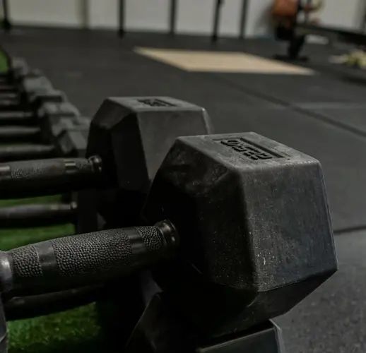 CrossFit equipment — pull-up cages and Olympic bars