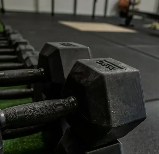 CrossFit equipment — pull-up cages and Olympic bars